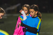 © PoppyPix - little Caucasian girls getting ready for football practice at night, medium shot, school team, team building. High quality photo
