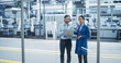 © Gorodenkoff - Caucasian Man and Asian Female Having a Conversation at an Industrial Facility. Advanced Factory Employees Working Together, Using Laptop Computer for Supervising Work Process in a Modern Facility