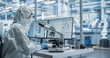 © Gorodenkoff - Research Factory Cleanroom: Engineer Wearing Coveralls, Gloves and Goggles while Using Microscope to Inspect a Microchip. Scientist Developing Advanced Electronics Component for the Precision Industry