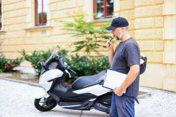 a man checks a motorcycle. Auto mechanic, car service, car rental, motorcycle rental. Copy space