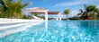 © Viktor - A blue swimming pool with palm trees in the background and a gazebo Blue sky in the foreground