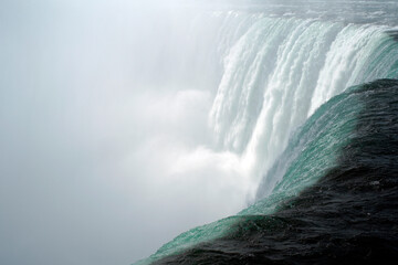 Close View from the edge at the water flow of the Niagara Falls