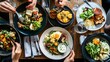 © Felippe Lopes - Overhead view of a table with delicious food, people are enjoying a meal together.