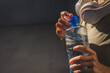 © Miljan Živković - close up hands unknown caucasian woman open plastic bottle of water