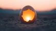 © Wed - Sunset light illuminating a cracked egg on sandy ground, symbolic of new beginnings and transformation
