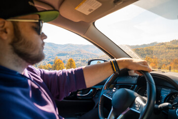 Poster - Man Driving Through Autumn Landscape