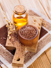 Canvas Print - Brown linen seeds, flaxseed vegetable oil on rustic wooden background. Healthy super food