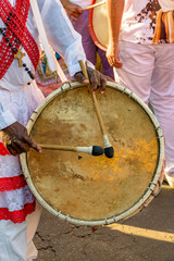 Poster - Drum player during a religious festival of Afro-Brazilian culture on the streets of Brazil