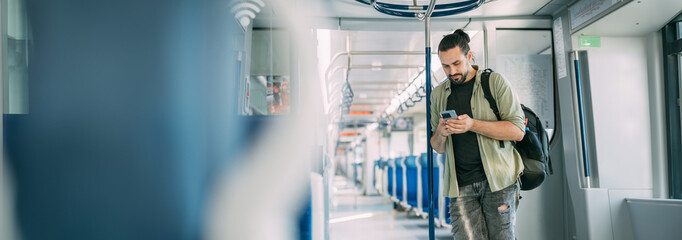 A Caucasian man rides on the train, in the skytrain, in the subway. Urban transport.