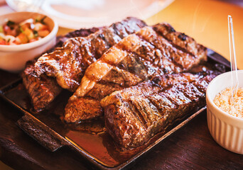 grilled picanha, traditional brazilian beef cut. meat served on the plate, luxury dinner.