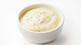 creamy Caesar dressing with a smooth, pale texture and flecks of Parmesan cheese