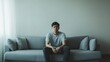 © Andrii  - Man in Thoughtful Reflection on Sofa with Sorrowful Expression