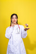 © Wasana - A woman in a white lab coat holding a brain model