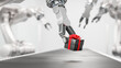 © Andreas Prott - A gift box being placed onto a conveyor belt by a robot arm. Tech christmas or birthday concept. Selective focus