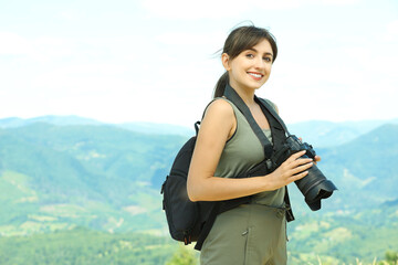 Poster - Photographer with backpack and camera in mountains