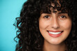 © New Africa - Happy young woman on light blue background. Dental veneers