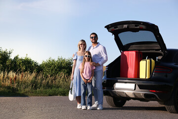 Wall Mural - Happy family near car with suitcases outdoors, space for text