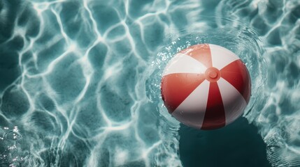 A red and white beach ball floating peacefully in a pool, representing a relaxing summer day by the water, and capturing the joyful essence of a vacation moment.