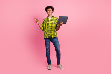 Sticker - Full length portrait of nice young man laptop direct finger empty space wear shirt isolated on pink color background