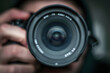 © john - photographer take pictures Snapshot with camera. man hand holding with camera looking through lens.Concept for photographing articles Professionally.