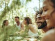 © Ryzhkov - Diverse Group of Young Adults Enjoying a Picnic in the Forest, Laughing, and Creating Positive Energy Under the Midday Sun