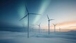 © Dulemegapixel - Several modern wind turbines are pictured against the backdrop of a night sky, showing a hint of aurora borealis. The landscape is blanketed in snow bathed in twilight glow.