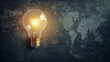 © Abubakar - light bulb on the table and a map on blackboard
