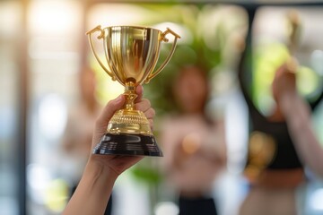 Wall Mural - A golden trophy symbolizes success as a team member is honored with applause, embodying the spirit of employee appreciation and achievement.