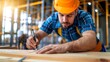 © suntaree - Construction worker checking and marking measurements on a wooden frame, with a focus on the details of the task and the construction siteâ€™s busy environment in the background
