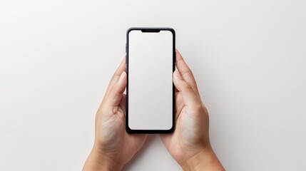 closeup two hands holding black smartphone with blank screen on white background