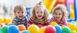 © raja - Portrait of three funny little kids playing in ball pit and enjoying time in childrens entertainment and play area