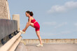 © Rob Wilkinson - Woman runner tying shoelaces preparing to go running and jogging outdoors, urban fitness.