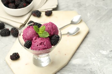 Wall Mural - Delicious blackberry sorbet, fresh berries and mint in glass dessert bowl on gray textured table