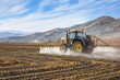 © Fotograf - Agricultural equipment spraying water on a farm or agricultural land, possibly for irrigation purposes