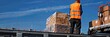© Brian - airport worker in orange vest loading cargo into cargo plane,