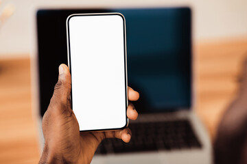 Fototapete - Useful App. Close-up of black man holding mobile phone with white blank screen. Mock up, rear view