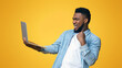 © Prostock-studio - Excited African American Man Celebrating Win With Laptop, Shouting And Clenching Fist Over Yellow Background With Free Space