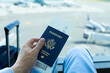 © kieferpix - Traveler at the airport with USA passport in hand, travel going on a holiday concept