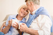 © Prostock-studio - Loving mature couple enjoying morning tea at autumn day, looking at each other