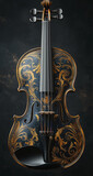 Black violin adorned with gold floral designs under a soft spotlight

