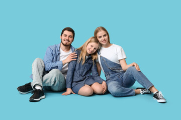 Poster - Happy family in stylish denim clothes sitting on blue background