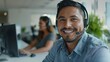 © LukaszDesign - Portrait of call center and customer service employee smiling at desk. Consultant, contact us, male sales agent, telemarketing, crm, help desk, or workplace support worker consulting
