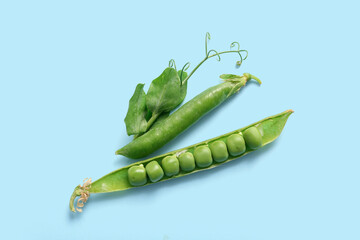 Wall Mural - Green peas on blue background