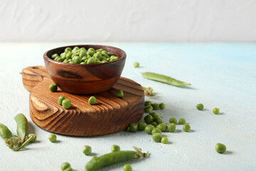 Poster - Bowl of green peas and board on light table