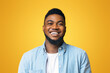© Prostock-studio - Portrait of young laughing african american man over yellow background, copy space