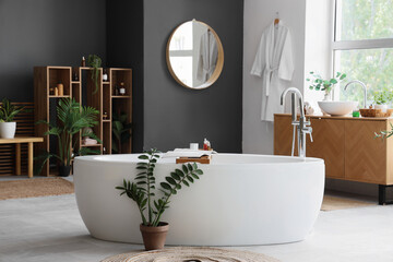 Poster - Interior of bathroom with bathtub, shelf unit and plants