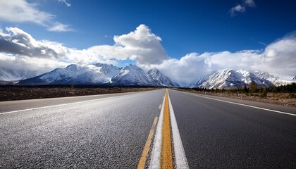 empty asphalt road with snow mountains in blue cloud sky