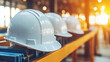 © BOW_NAPASORN - Three white hard hats are lined up on a metal shelf. The hats are all the same color and size, and they are placed in a row. Concept of organization and safety