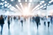 © InfiniteStudio - Crowd of people walking through a brightly lit convention center during an event