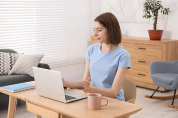 Wall Mural - Teenager working with laptop at home. Remote job